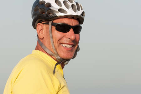 Portrait of a senior man with a cycling helmet