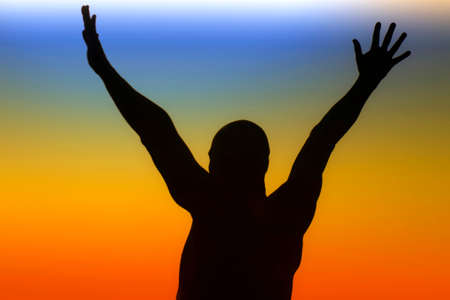 Man silhouette over a rainbow backgroundの写真素材