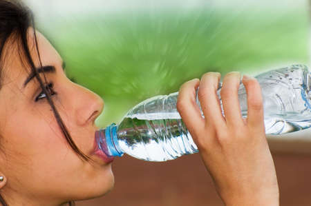 Young woman drinking water from a bottleの写真素材