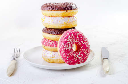 multi-colored donuts on a white background with copy spaceの写真素材