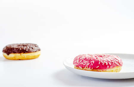 multi-colored donuts on a white background with copy space