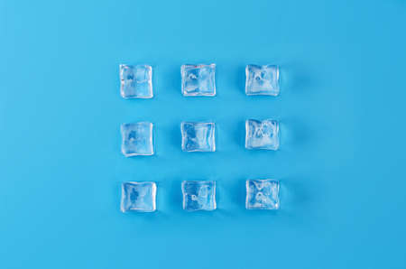 Ice cubes with pastel blue background. Composition with copy space. Minimal concept image.の写真素材