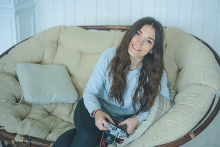 Portrait of smiling young girl photographer holding retro cameraの写真素材
