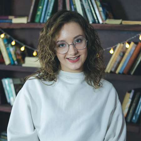 Portrait of smiling caucasian student girl in glassesの写真素材