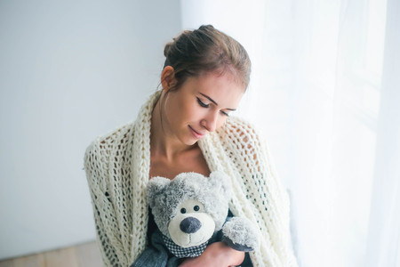 Young beautiful woman holding teddy bear plush for Valentines Dayの写真素材