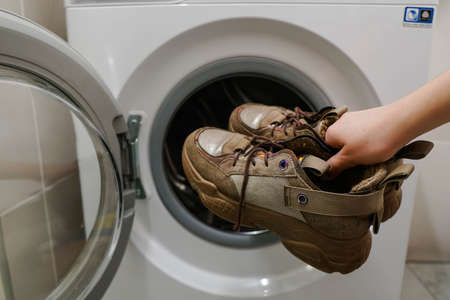 Washing dirty sneakers in the washing machine. Cleaning sport shoes.の写真素材