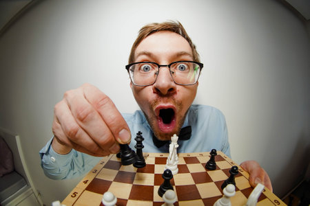 Fisheye portrait of crazy nerd chess player with glasses, looking at cameraの写真素材