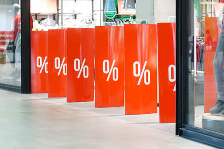 Enter of a clothing store with percent sign. Concept of shopping and sales. Black Friday.の写真素材