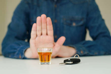 Drink no drive concept. Man showing stop gesture to drunk driving.の写真素材