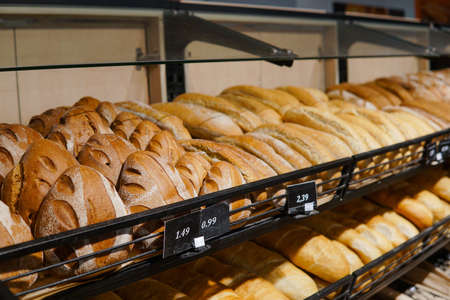 Variety of fresh bakery products on the shelf at store.