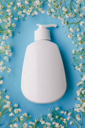Mockup of unbranded white shower gel bottle on blue background. Minimalism.の写真素材