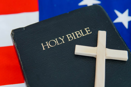 Old Holy Bible with a cross on flag of USA.の写真素材