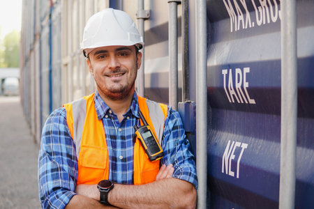 Portrait of smiling container man worker in container warehouse. Import and export shipping....