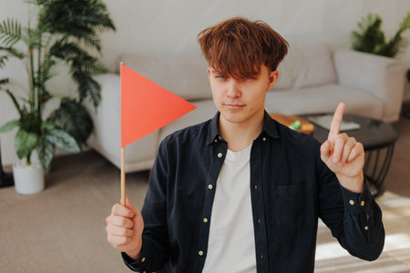 Young man with red flag. Choosing a partner for a relationship concept. Bad qualities of a...