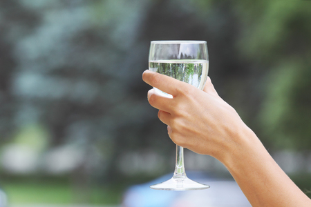 Woman's hand with a glass of waterの写真素材