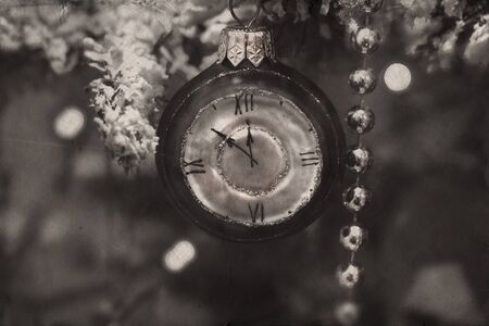 lock hanging on the Christmas tree branch in retro styleの写真素材