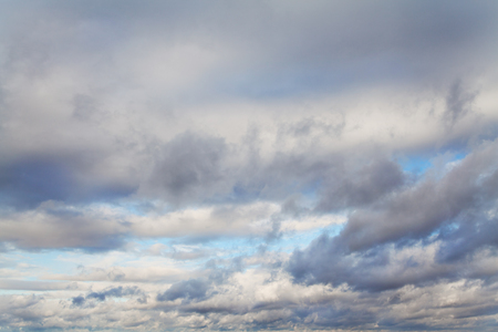 Blue sky with white and gray cloudsの写真素材