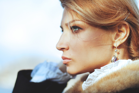 Close-up portrait of beautiful girl in vintage style on autumn nature backgroundの写真素材