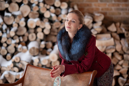 Gentlewoman stand near bench in winterの写真素材