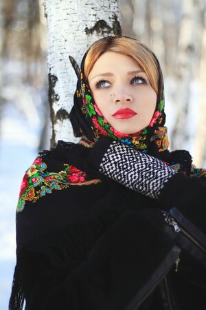 Portrait of a beautiful young woman in a winter birch forestの写真素材