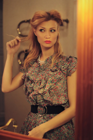 Portrait of a beautiful blonde in retro style in the mirrorの写真素材