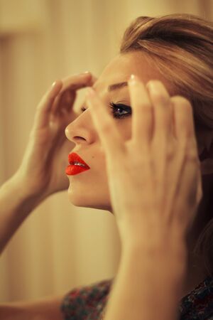 Portrait in profile of a beautiful blonde in retro styleの写真素材