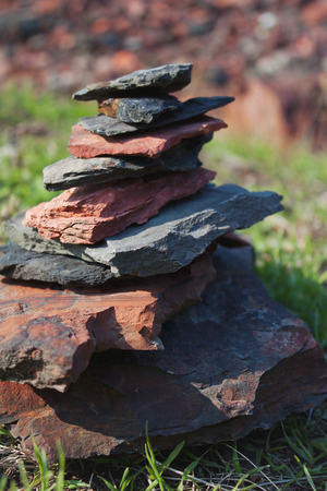 Pyramid of pieces of rock on green grassの写真素材