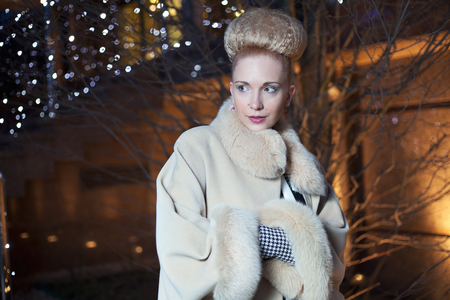 Elegant blond woman in retro style posing on the street in the evening autumnの写真素材