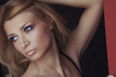 Portrait of a beautiful girl on dark backgroundの写真素材