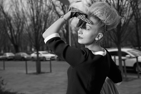 Elegant blond woman in retro style posing at autumn streetの写真素材