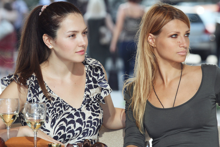 Portrait of two young women in street cafeの写真素材