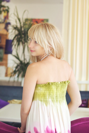 Portrait in profile of a beautiful romantic girl in summer dressの写真素材