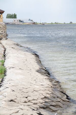Like stoneware tiles protect the waterfront from the waves