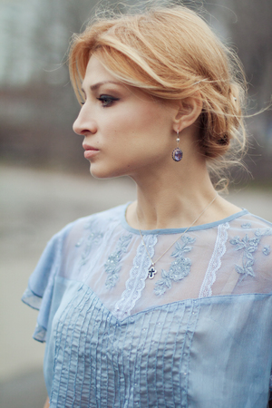 Close-up portrait of beautiful girl in vintage style on nature backgroundの写真素材