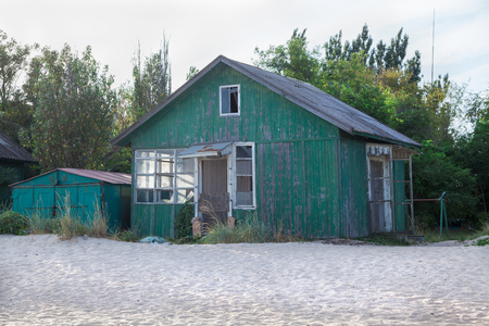 Dilapidated apartment buildings of abandoned soviet resting base on the sea coastの写真素材