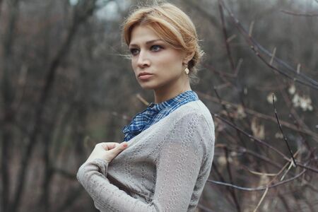 Portrait of beautiful girl in vintage style on nature backgroundの写真素材