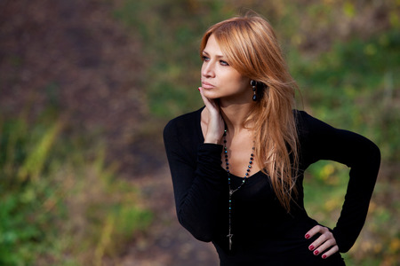 Portrait of a beautiful girl on mysterious trail in autumn forestの写真素材