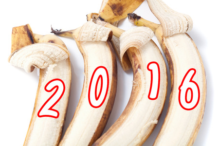 Four partially peeled banana on which painted figures of 2016 monkey year