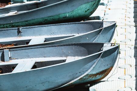 Three blue boats are on the quay of the curved elements sunny day