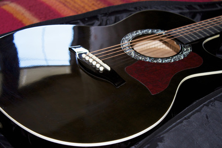 upper deck of an acoustic guitar. Strings, holder and plug closeup