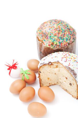 One cut and one whole Easter cake and six eggs with festive ribbons on a white background
の写真素材