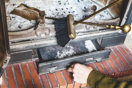 Hand pallet extinguished man opens fire with ashes. Near brass shovel and brush
の写真素材
