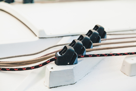 Black stoppers for the ropes on the boat set on a stand in a row
の写真素材