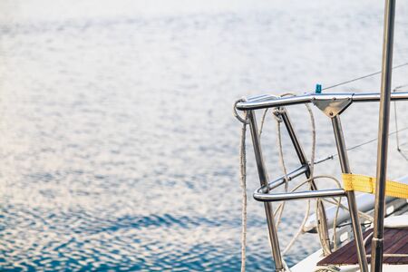 Handrails of stainless steel railings on the deck of a yacht on a background of waterの写真素材