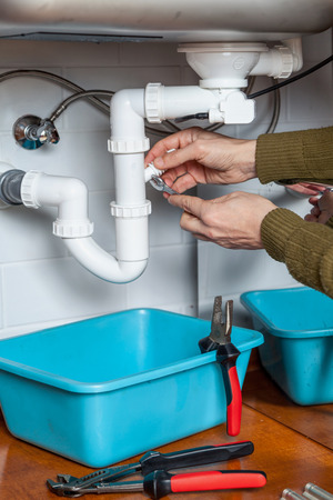 Repair of hydraulic valve kitchen sink with a wrenchの写真素材