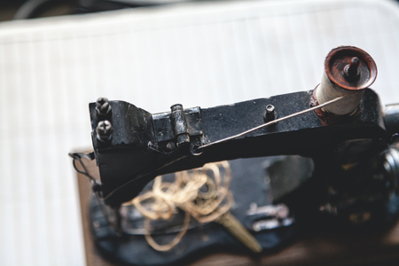 Vintage sewing machine with a coil of white thread closeup. View from aboveの写真素材