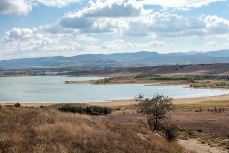 beautiful landscape. Wide bay against the backdrop of mountains and cloudy skyの写真素材
