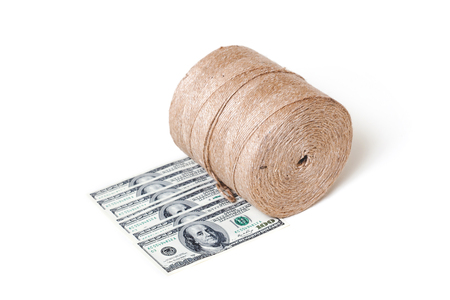 New roll flax cord standing on some banknotes on a white background
の写真素材