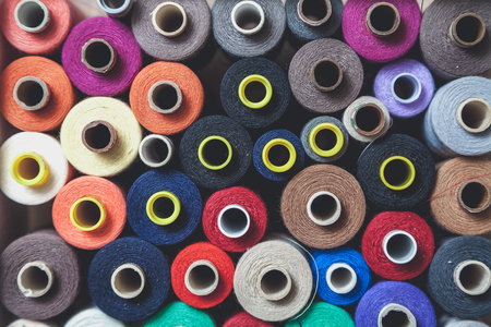 Coils with threads of different colors and diameters are tight to each other. View from above