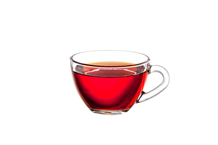 Transparent glass cup with brown tea on a white background close-up.の写真素材
